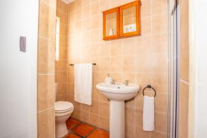 a bathroom with a toilet and a sink at Benguela Cottage in Langebaan +46 photos