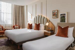 a hotel room with two beds and a chair at The Malone Hotel in Belfast +172 photos