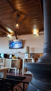 a room with a table and a tv on the wall at Altos de Soberana in El Calafate