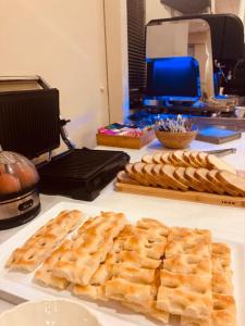 a table with a plate of bread and waffles on it at Hotel Elisabetta in Sestri Levante