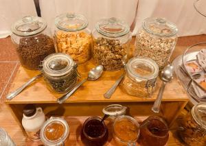 a table with several jars of food and spoons at Hotel Elisabetta in Sestri Levante +30 photos