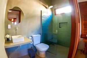 a bathroom with a toilet and a sink and a shower at Maysu Patacho Chalé Piscina Privativa in Pôrto de Pedras +56 photos