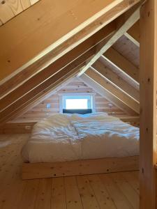 a bed in the attic of a log cabin at Deer Cottage in Sylte