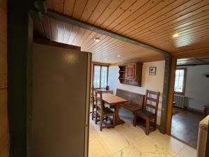 a kitchen and dining room with a table and chairs at Le Vieux Chalet in Gstaad +10 photos