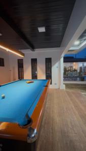 a pool table in the middle of a room at Villa de Flynn Private Resort in Bauang