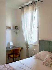 a bedroom with a bed and a desk and a window at Nashi Garden Apartment Split with City View & Parking in Solin