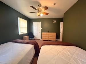 a bedroom with two beds and a ceiling fan at Get Away Casino in Bensalem