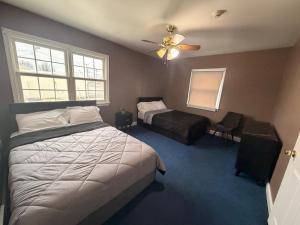 a bedroom with a bed and a ceiling fan at Get Away Casino in Bensalem