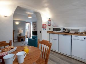 a kitchen and dining room with a wooden table at Tuckenhay, 4 Castle Cottage- Fcn in Ashsprington +36 photos
