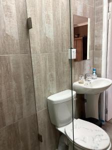 a bathroom with a toilet and a sink at StayComfy on Jasmin in Oakdale +6 photos