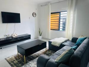 a living room with a couch and a coffee table at Elvara's Nest in Lusaka