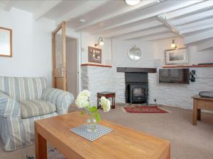 a living room with a couch and a fireplace at Tuckenhay, 1 Castle Cottage - Fck in Ashsprington