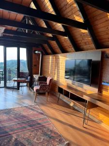 a living room with a large television on a wall at Defne Bungalow Yomra in Yomra
