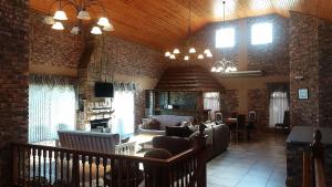 a large living room with a couch and a fireplace at Dolphin Villa in Gqeberha