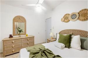 a bedroom with a bed and a dresser and a mirror at Colonial Zone 2BR Apartment Prime Location in Santo Domingo