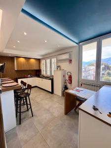 a large kitchen with a blue ceiling in a room at Mongibello Rooftop in Mondello