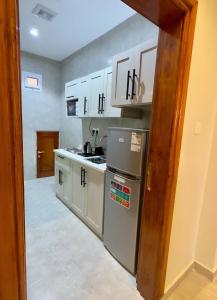 a kitchen with a sink and a stove top oven at Alturya in Al-ʿUla