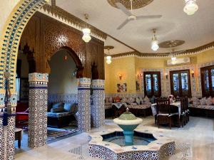 a lobby with a fountain in the middle of a building at Villa Barba Luxor in Luxor