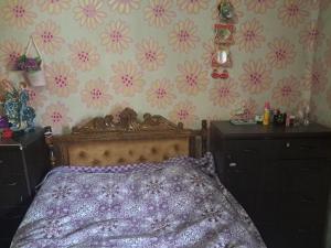 a bedroom with a bed and flowers on the wall at Hotel kazbegi1 in Ach'khoti