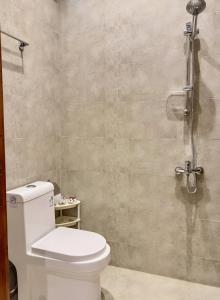 a bathroom with a toilet and a shower at Alturya in Al-ʿUla