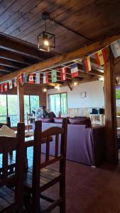 a room with a table and flags hanging from a ceiling at Altos de Soberana in El Calafate