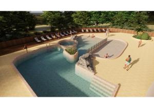 an overhead view of a swimming pool with people in it at Flower Camping Le Pont du Tarn in Florac +31 photos