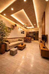 a large living room with a couch and a table at Amara Lux Rivage wynad in Vythiri