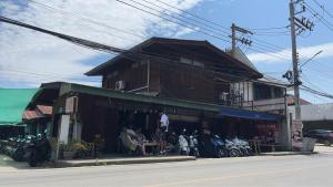 a group of people sitting outside of a building at Baan Pai Hostel in Pai