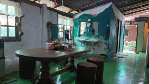 a bathroom with a table and a mirror and a sink at Baan Pai Hostel in Pai