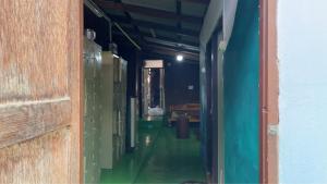 an empty hallway of a room with green walls at Baan Pai Hostel in Pai