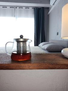 a tea kettle on a wooden counter with a bed at Ocean View Studio 4 in Mindelo