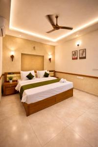 a bedroom with two beds and a ceiling fan at Amara Lux Rivage wynad in Vythiri +18 photos