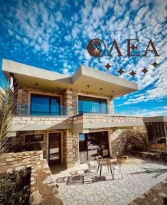 a building with a sign on top of it at Olea Village in Potos