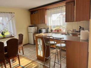 a kitchen with a counter and some chairs in it at But in Pasłęk