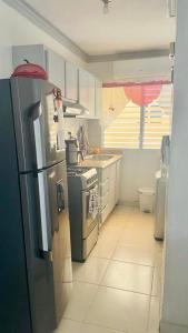 a kitchen with a refrigerator and a stove at Apartment in a comfortable and quiet area in Pantoja
