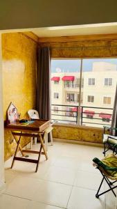 a living room with a table and a large window at Apartment in a comfortable and quiet area in Pantoja