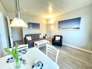 a living room with a table and a couch at App 12-A67 in Westerland