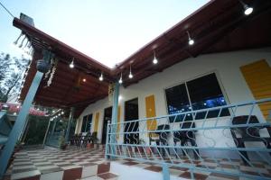 a porch of a house with a balcony at Malnad Mist in Attigundi +9 photos