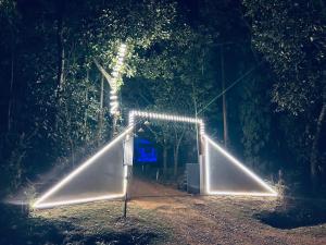 a swing set with lights in a park at night at Malnad Mist in Attigundi