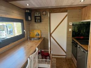 a kitchen with a counter with a sink and a counter sidx sidx sidx at La Tiny House de Nanou in Rochefort