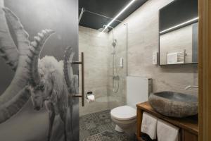 a bathroom with a dragon mural on the wall at Hotel Jägerhof in Zermatt +116 photos