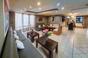 a large living room with couches and tables and flowers at Cloud9 Hotel Shisha & Cocktail Bar - Adults Only in Malia