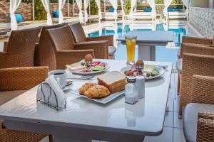 a table with a plate of food and drinks on it at Cloud9 Hotel Shisha & Cocktail Bar - Adults Only in Malia