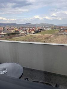 a balcony with a toilet and a view of a town at Confort Suite in Alba Iulia