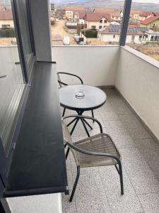 a small table and chairs on a balcony with a view at Confort Suite in Alba Iulia