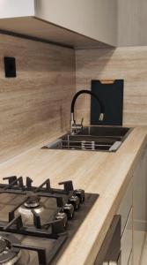 a kitchen with a sink and a stove at Ocean View Studio 4 in Mindelo