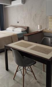 a table and a chair in a room with two beds at Ocean View Studio 4 in Mindelo