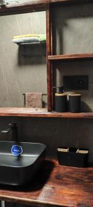 a kitchen with a sink on a wooden shelf at Ocean View Studio 4 in Mindelo +18 photos