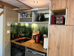 a kitchen with a counter top in a tiny house at La Tiny House de Nanou in Rochefort