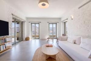 a living room with a white couch and a table at Lithi House in Grionísi